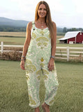 Woman wearing a sage-green jumpsuit with a gold floral damask print on a farm