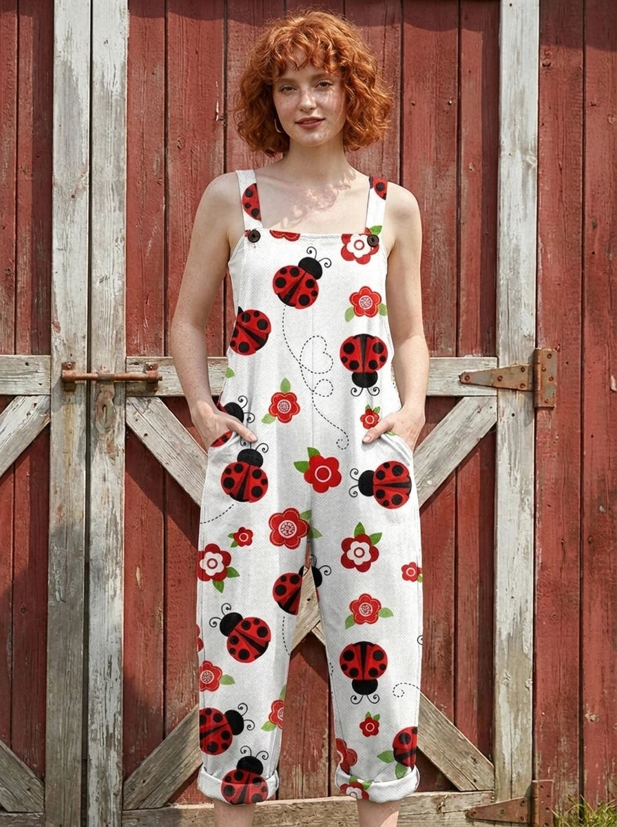 Woman in a white ladybug print jumpsuit standing by a red barn door