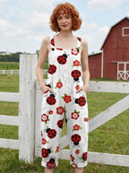 Woman in a white ladybug print jumpsuit standing by a farm gate