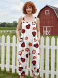 Woman wearing a white jumpsuit with a red ladybug and floral print on a farm