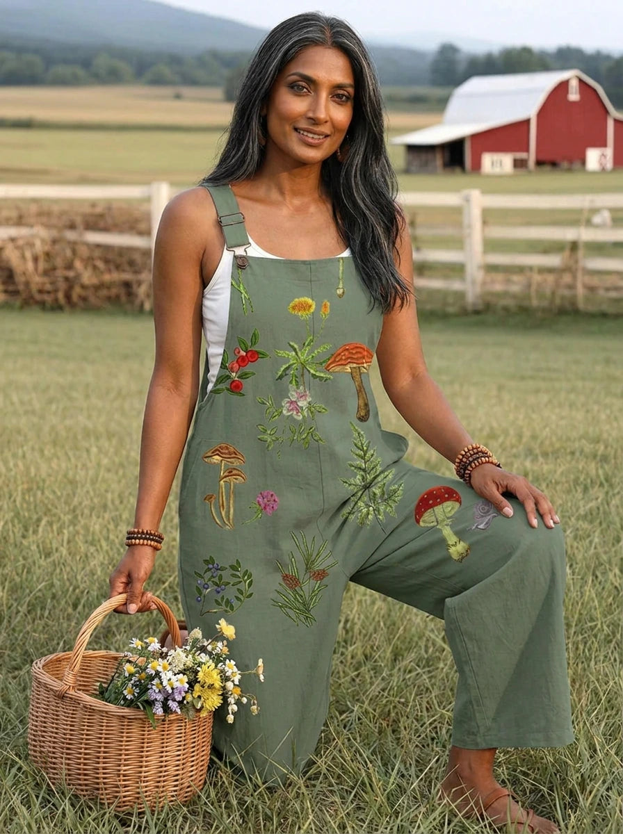 Woman standing near a wooden fence wearing a nature-inspired embroidery jumpsuit