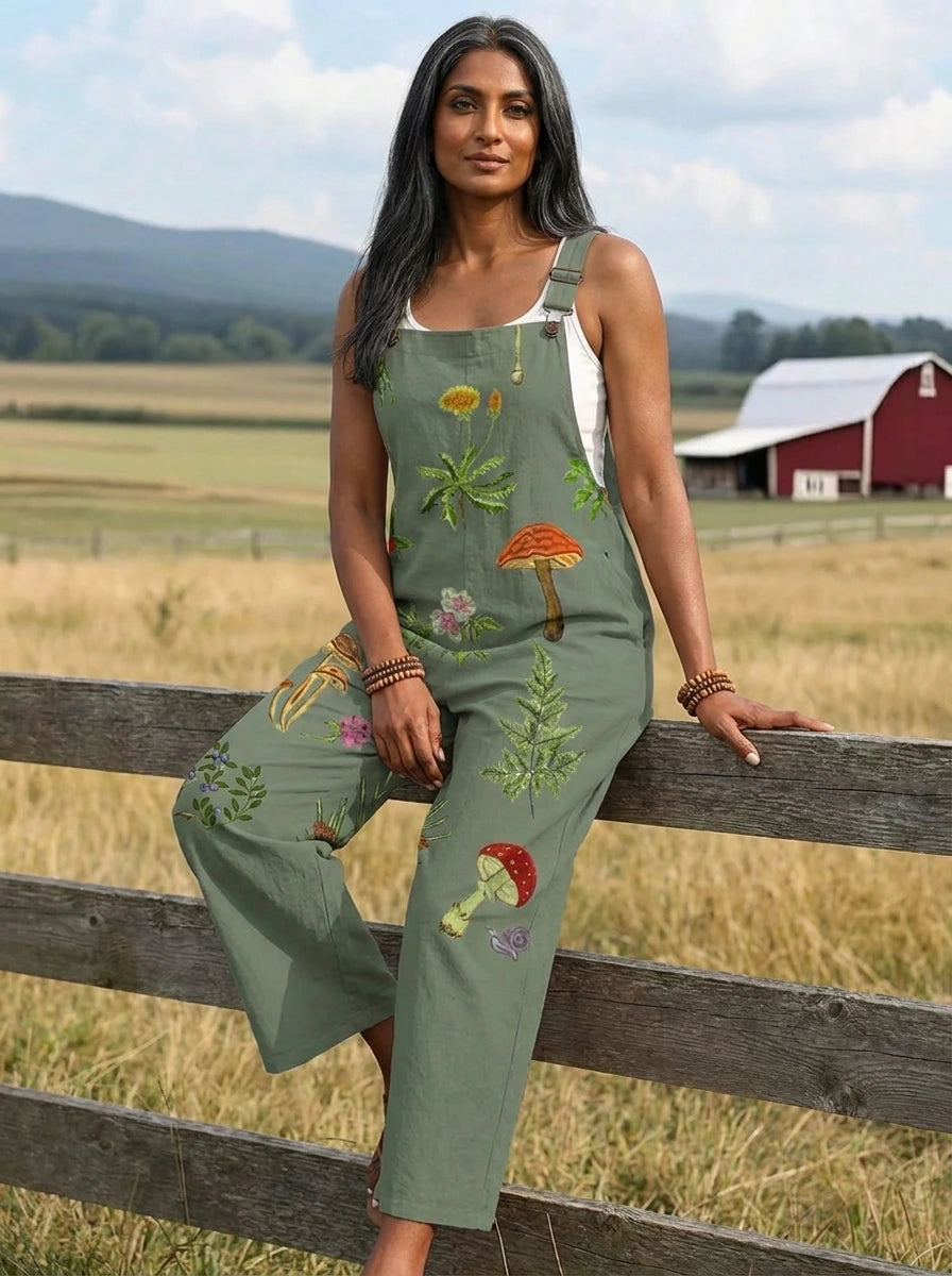 Woman sitting on a wooden fence wearing a nature-inspired embroidery jumpsuit
