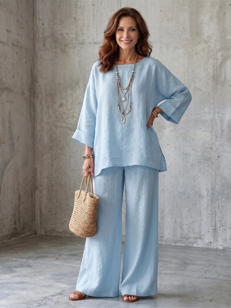 Woman wearing a blue oversized tunic wide-leg set - studio photo