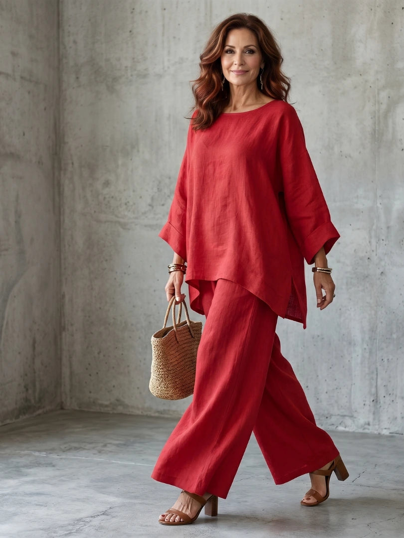 Woman wearing a red oversized tunic wide-leg set - studio photo
