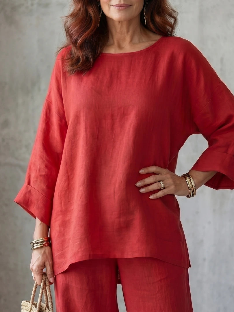 Woman wearing a red oversized tunic wide-leg set - studio photo