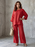 Woman wearing a red oversized tunic wide-leg set - studio photo