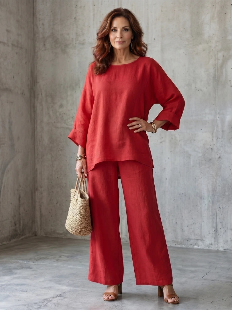 Woman wearing a red oversized tunic wide-leg set - studio photo