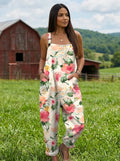 Woman wearing a petal floral print jumpsuit in a farm setting