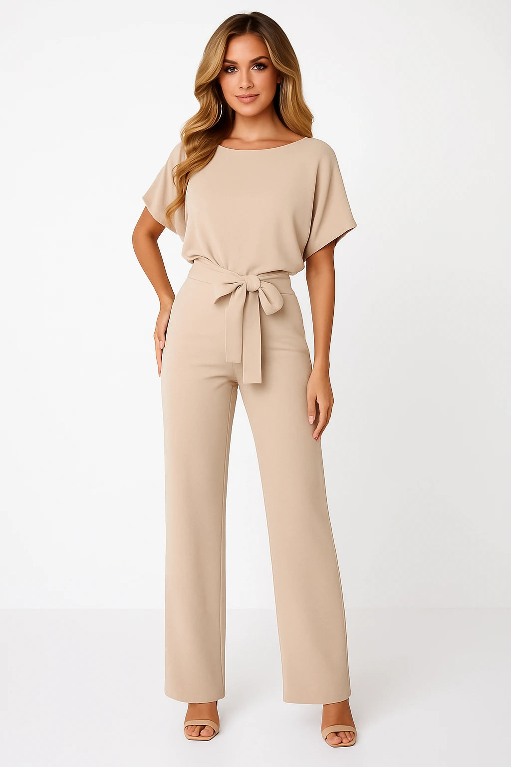 Woman wearing a beige ponte knit batwing jumpsuit - studio photo