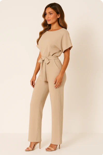 Woman wearing a beige ponte knit batwing jumpsuit - studio photo