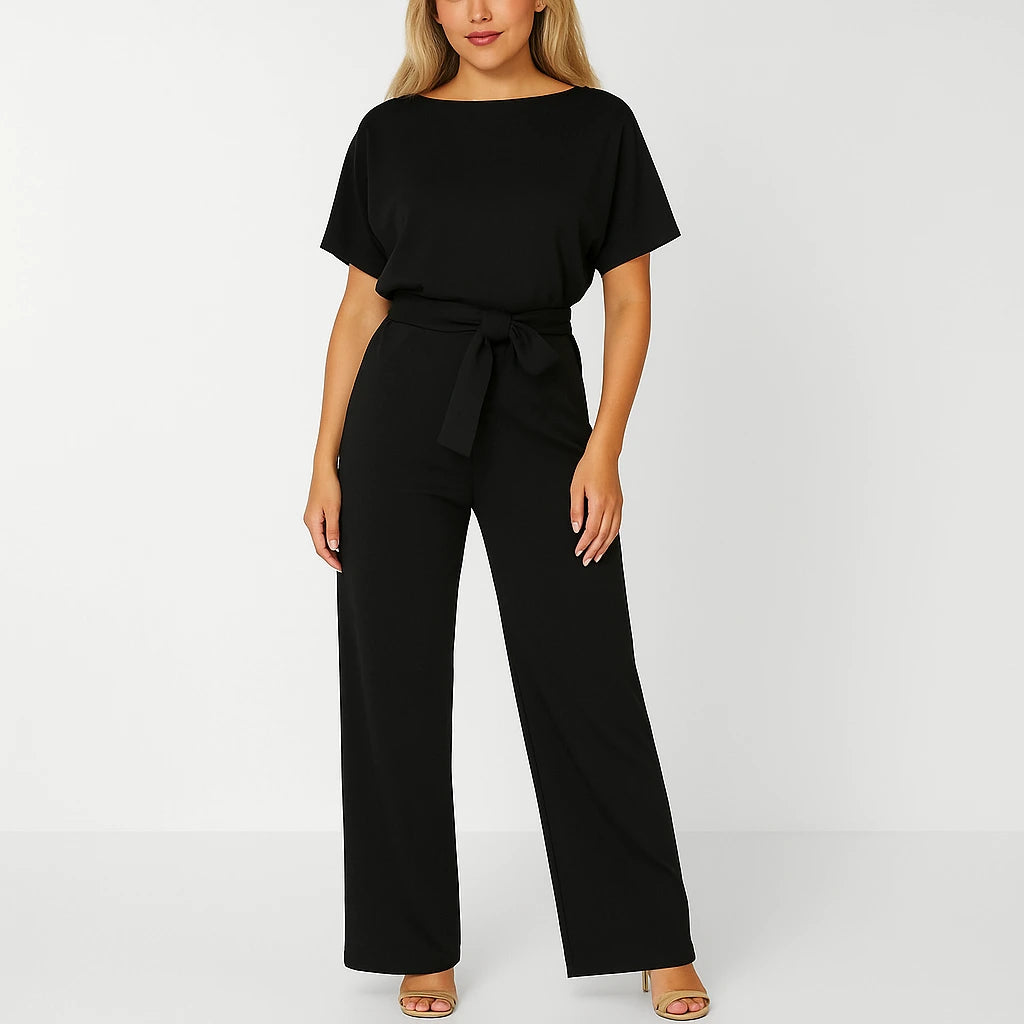 Woman wearing a black ponte knit batwing jumpsuit - studio photo