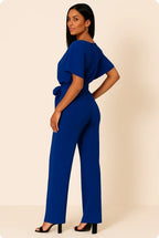 Woman wearing a blue ponte knit batwing jumpsuit - studio photo