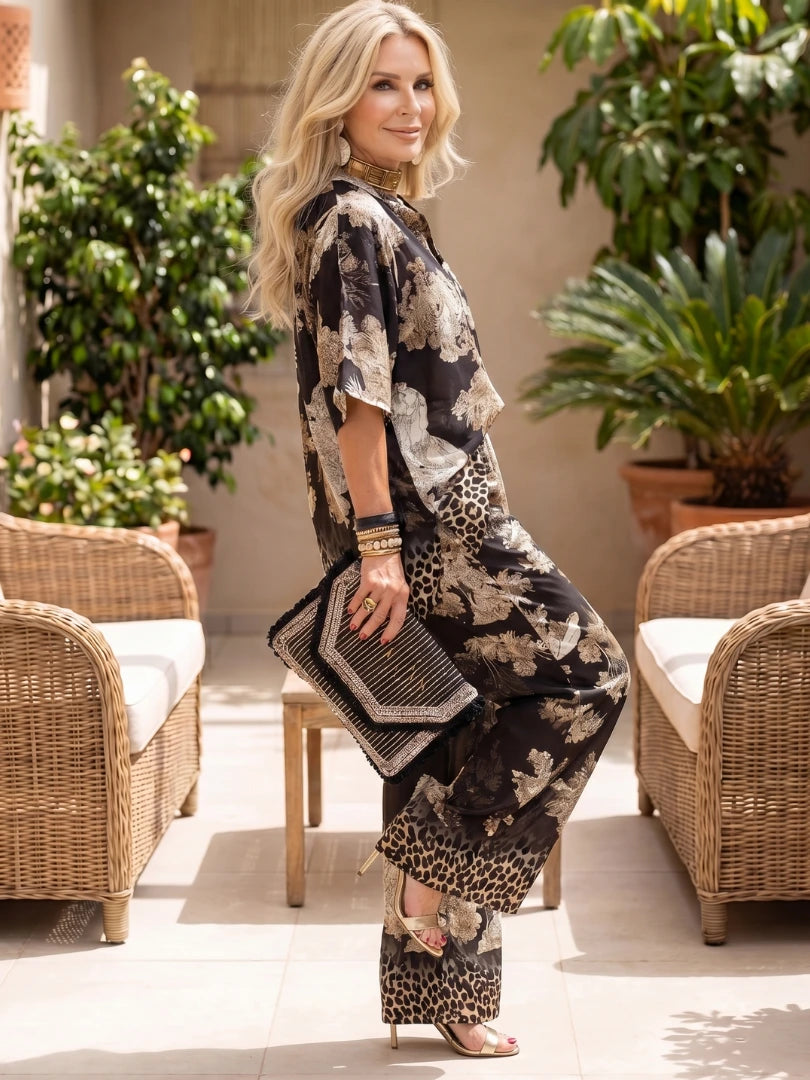 Woman wearing a black printed wide leg wrap set - lifestyle photo