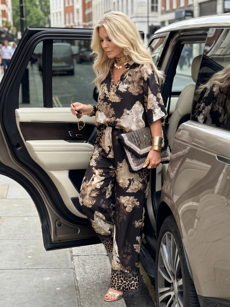 Woman wearing a black printed wide leg wrap set - lifestyle photo