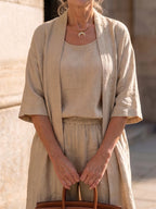 Woman wearing a beige relaxed three-piece set - studio photo