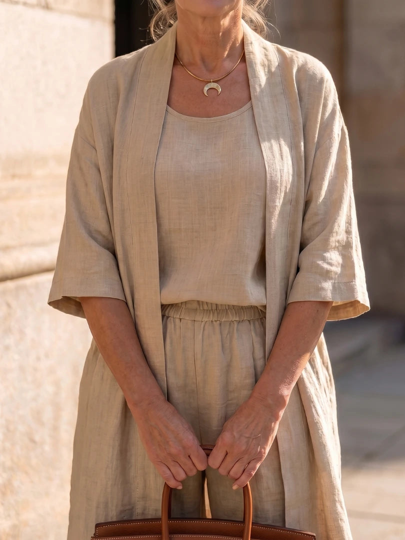 Woman wearing a beige relaxed three-piece set - studio photo