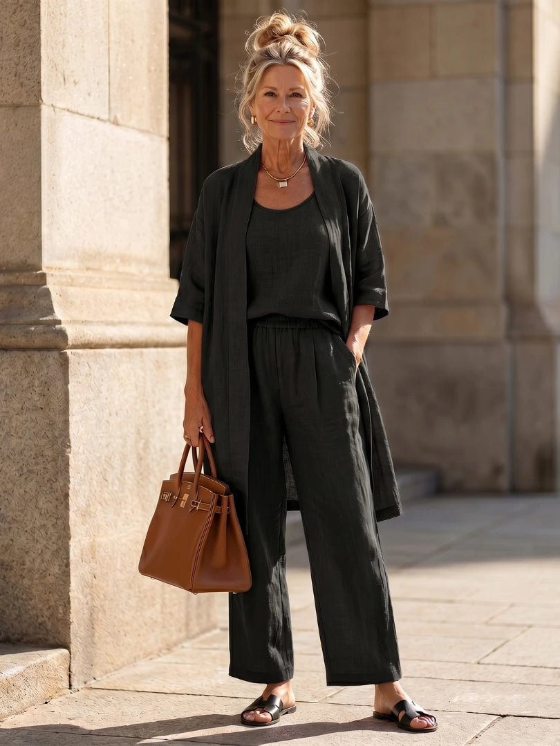 Woman wearing a black relaxed three piece set jumpsuit - editorial style photo