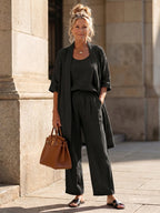 Woman wearing a black relaxed three piece set jumpsuit - editorial style photo