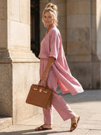 Woman wearing a pink relaxed three-piece set - studio photo