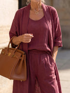 Woman wearing a red relaxed three piece set jumpsuit - editorial style photo