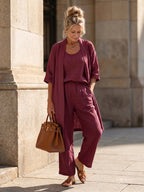 Woman wearing a red relaxed three piece set jumpsuit - editorial style photo