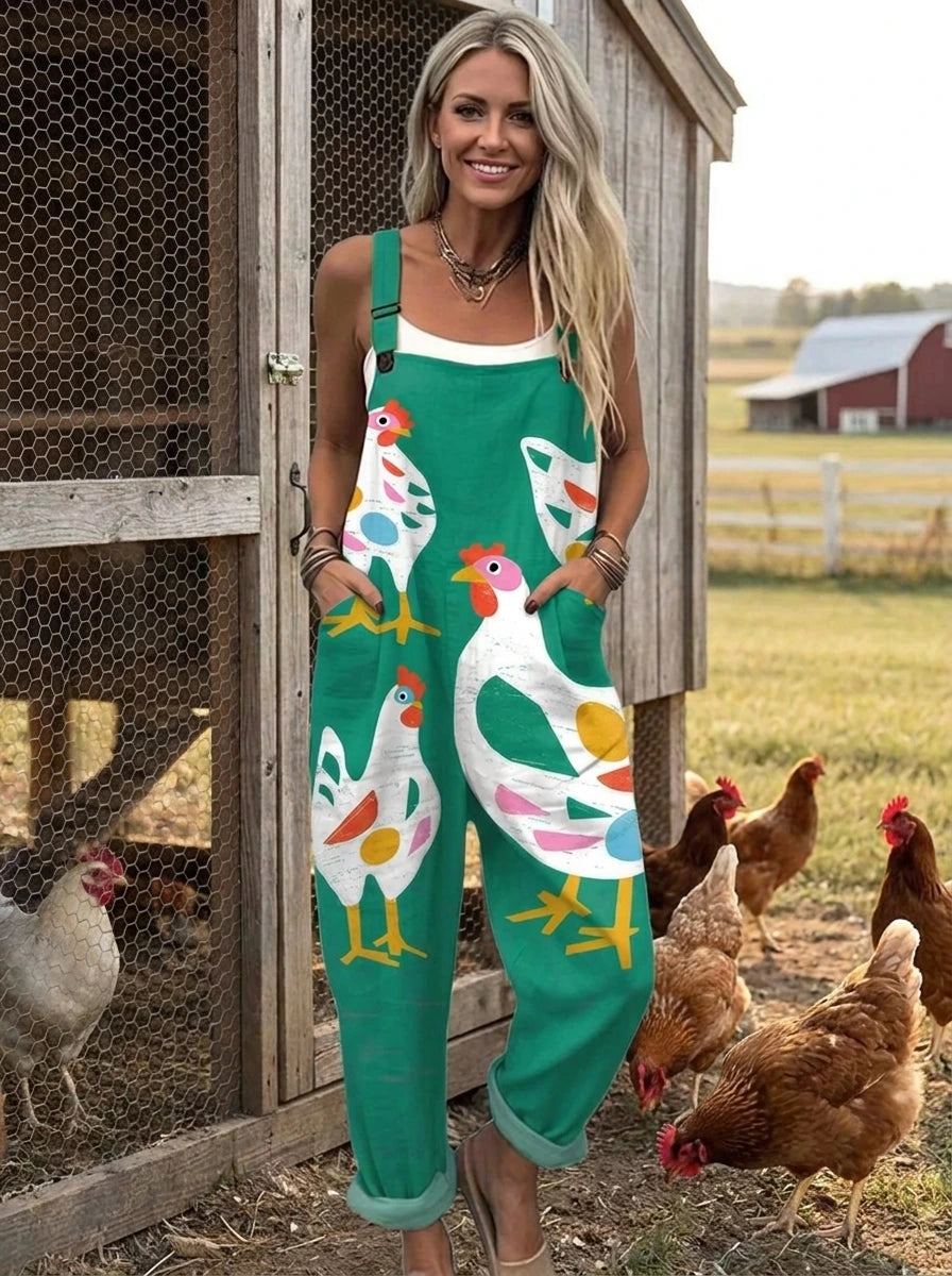 Woman in a teal-green rooster print jumpsuit near a wooden chicken coop