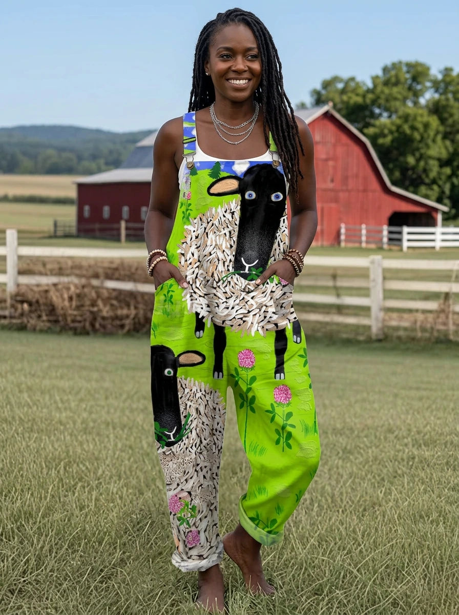 Woman wearing a green sheep and floral print sleeveless wide-leg overall jumpsuit standing in a farm field