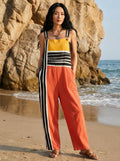 Woman wearing a striped color-block jumpsuit on a beach