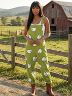 Woman wearing a green chick-print short-sleeve jumpsuit, different pose on a rural farm