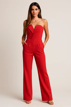 Woman wearing a red strapless tuxedo jumpsuit - studio photo