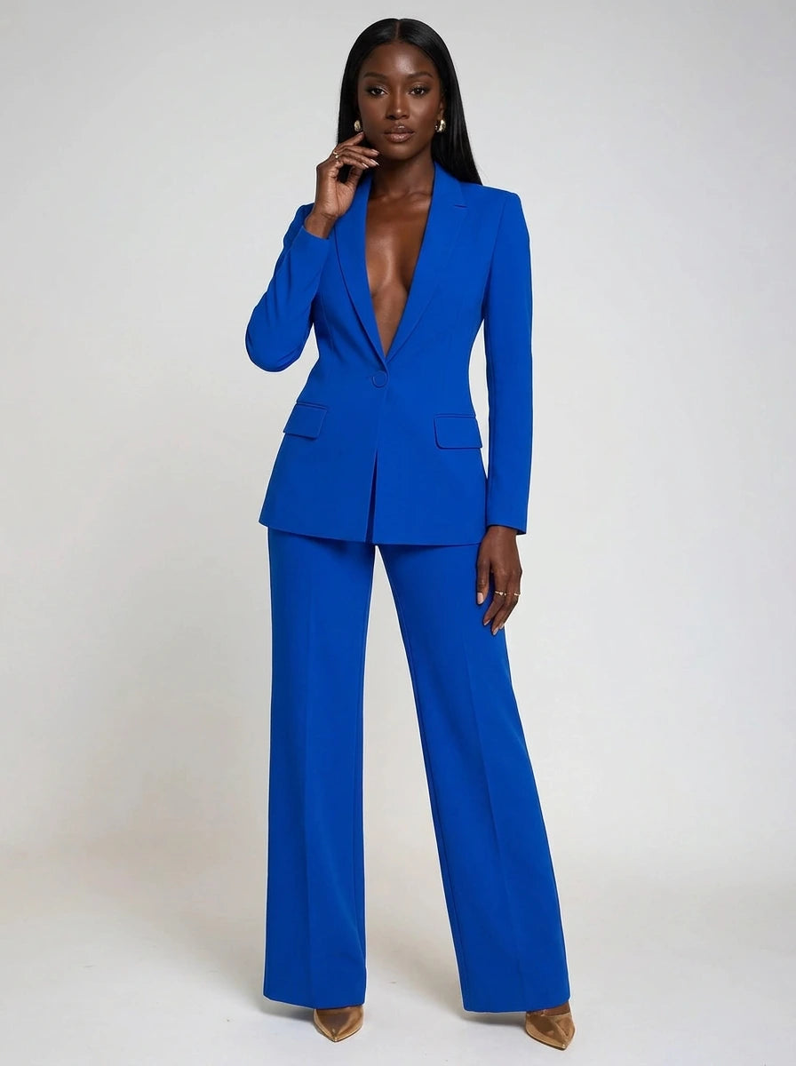 Woman wearing a blue stretch crepe two-piece jumpsuit, studio photo, front pose
