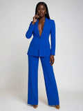 Woman wearing a blue stretch crepe two-piece jumpsuit, studio photo, front pose