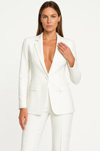 Woman wearing a white stretch crepe two-piece jumpsuit - studio photo