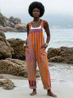 Woman wearing a sunset print jumpsuit on a beach