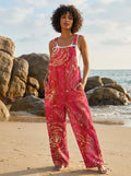 Woman wearing a wildflower print jumpsuit on a beach