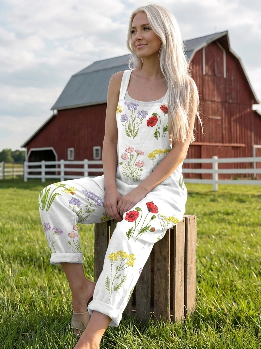 Woman walking in a farm field wearing a wildflower print jumpsuit