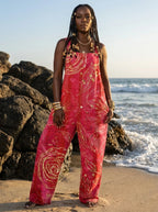 Woman wearing a wildflower print wide-leg jumpsuit on a beach
