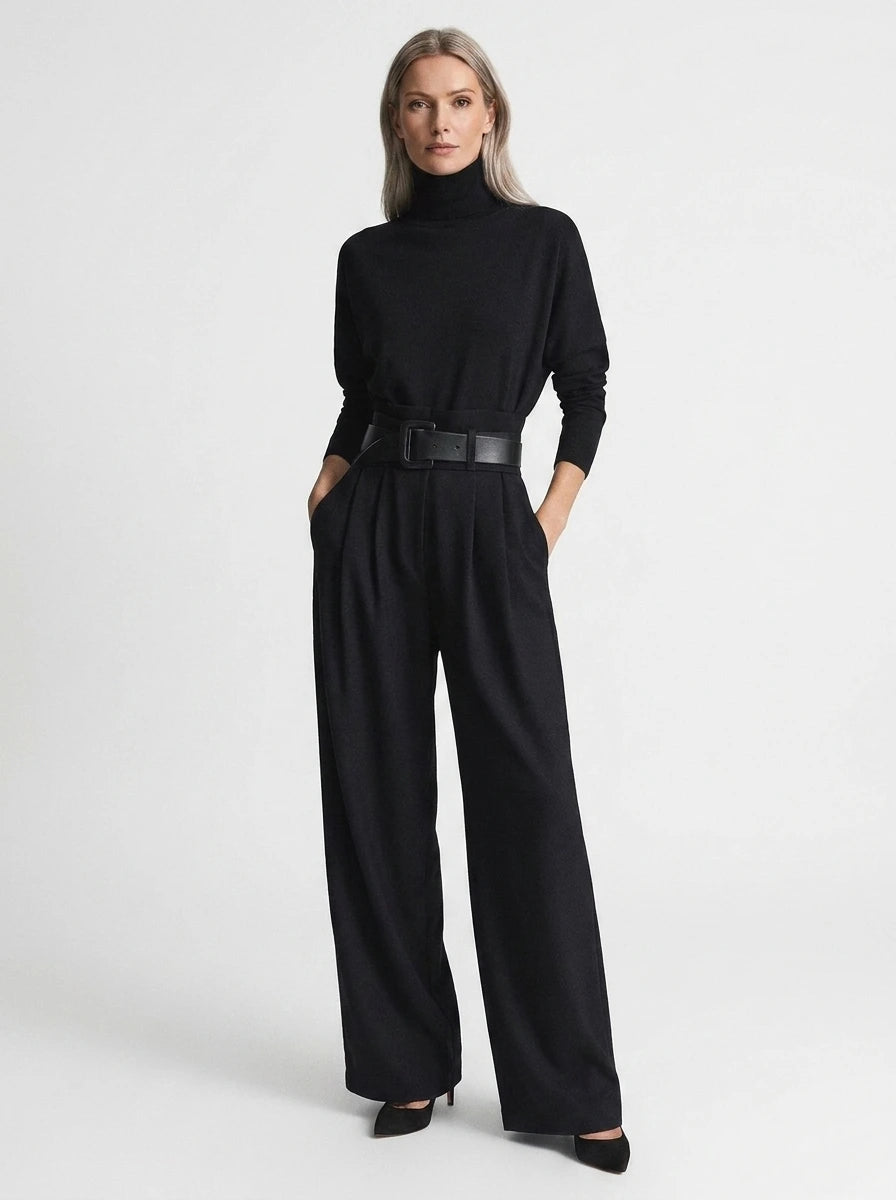 Black elegant casual jumpsuit with relaxed fit, turtleneck, wide-leg trousers, and matching black belt, studio front view.