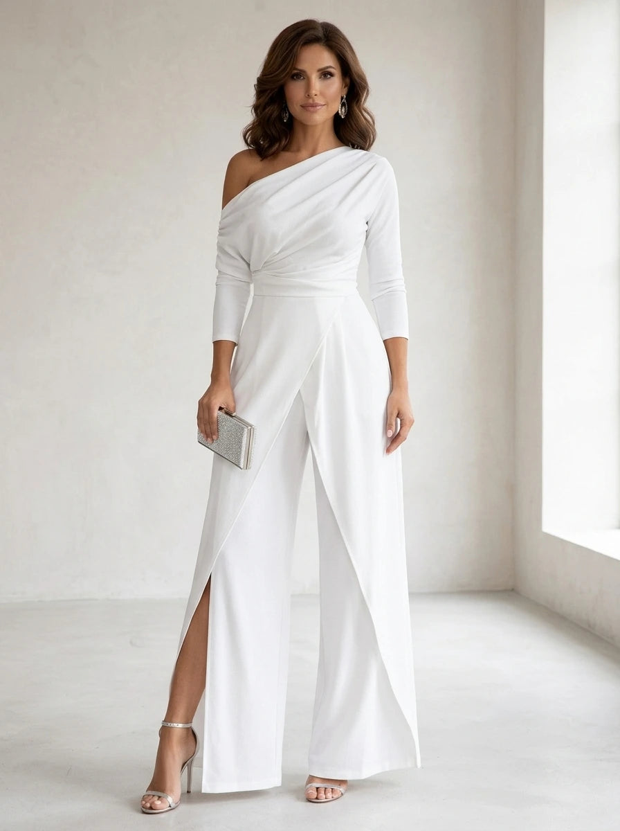 Driftly white asymmetrical one-shoulder jumpsuit with crossed detail and flowing wide-leg trousers, in a minimalist studio setting with soft window light.