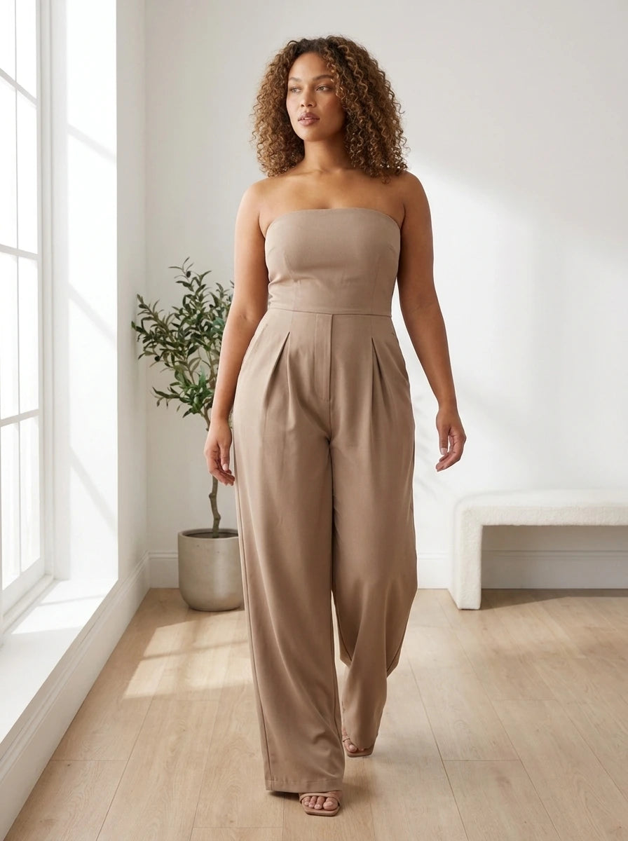 Woman wearing a beige strapless wide-leg jumpsuit in a bright minimalist interior