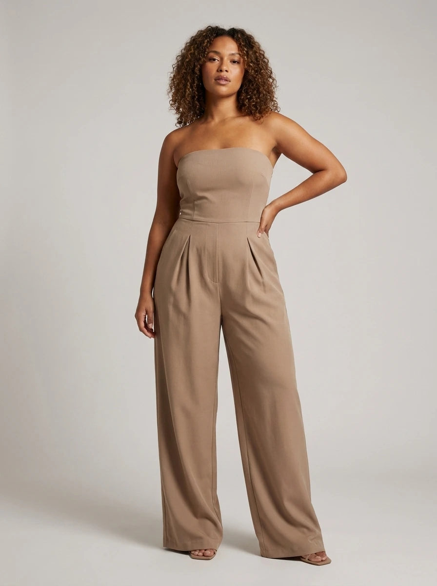 Woman wearing a beige strapless wide-leg jumpsuit with fitted top, studio shot