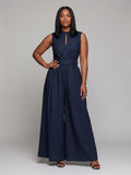 Woman wearing a dark blue striped wide-leg jumpsuit with high collar, studio shot