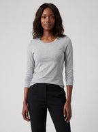 Woman wearing a gray cotton long sleeve t-shirt, studio front view