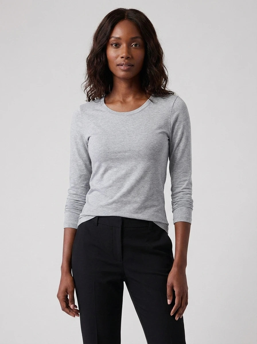 Woman wearing a gray cotton long sleeve t-shirt, studio front view