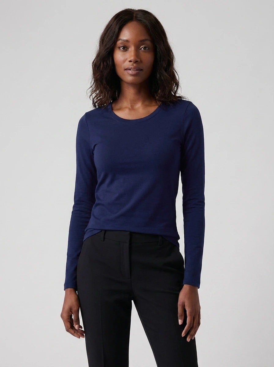 Woman wearing a navy cotton long sleeve t-shirt, studio front view