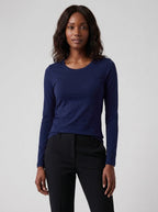 Woman wearing a navy cotton long sleeve t-shirt, studio front view