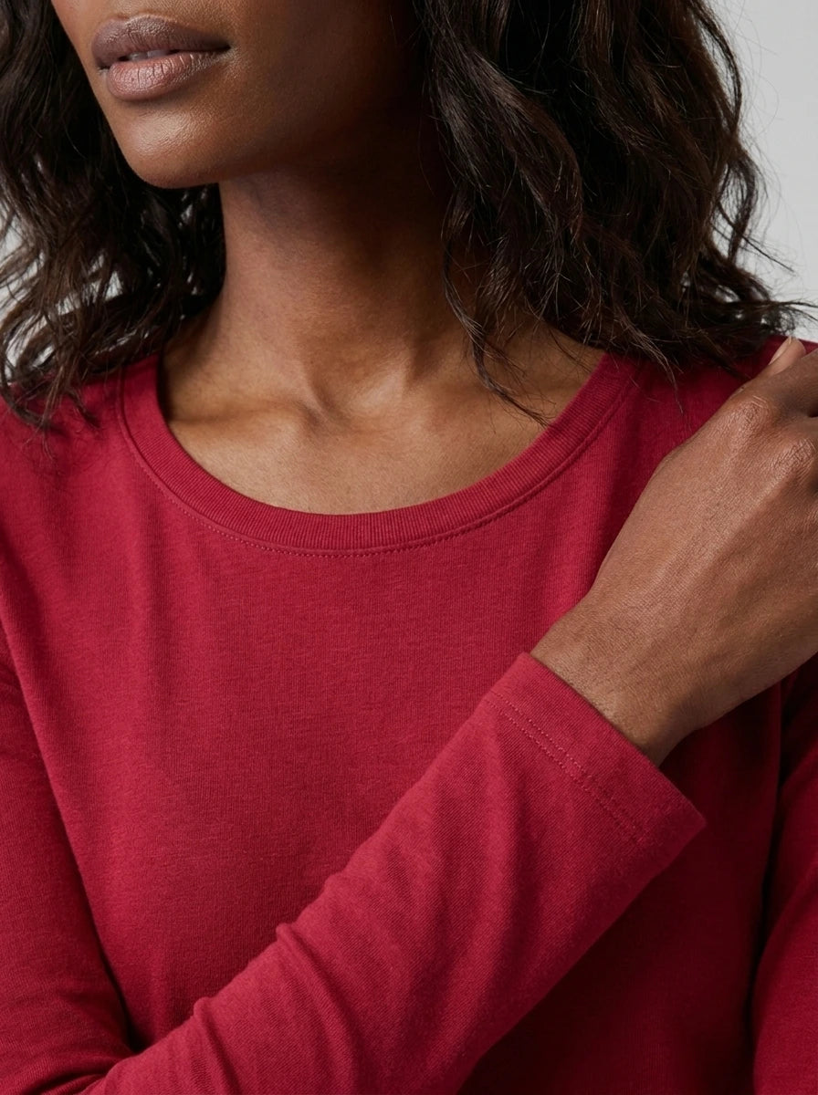 Close-up detail of red cotton long sleeve t-shirt neckline and cuff