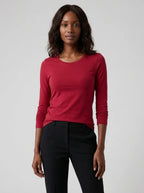 Woman wearing a red cotton long sleeve t-shirt, studio front view