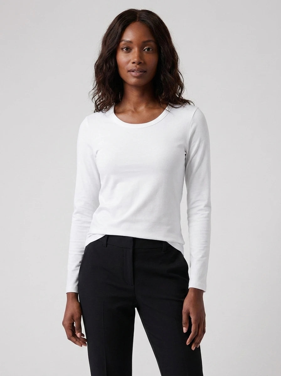 Woman wearing a white cotton long sleeve t-shirt, studio front view