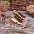 Woman wearing a gold wedge heeled platform orthopedic sandal - lifestyle photo